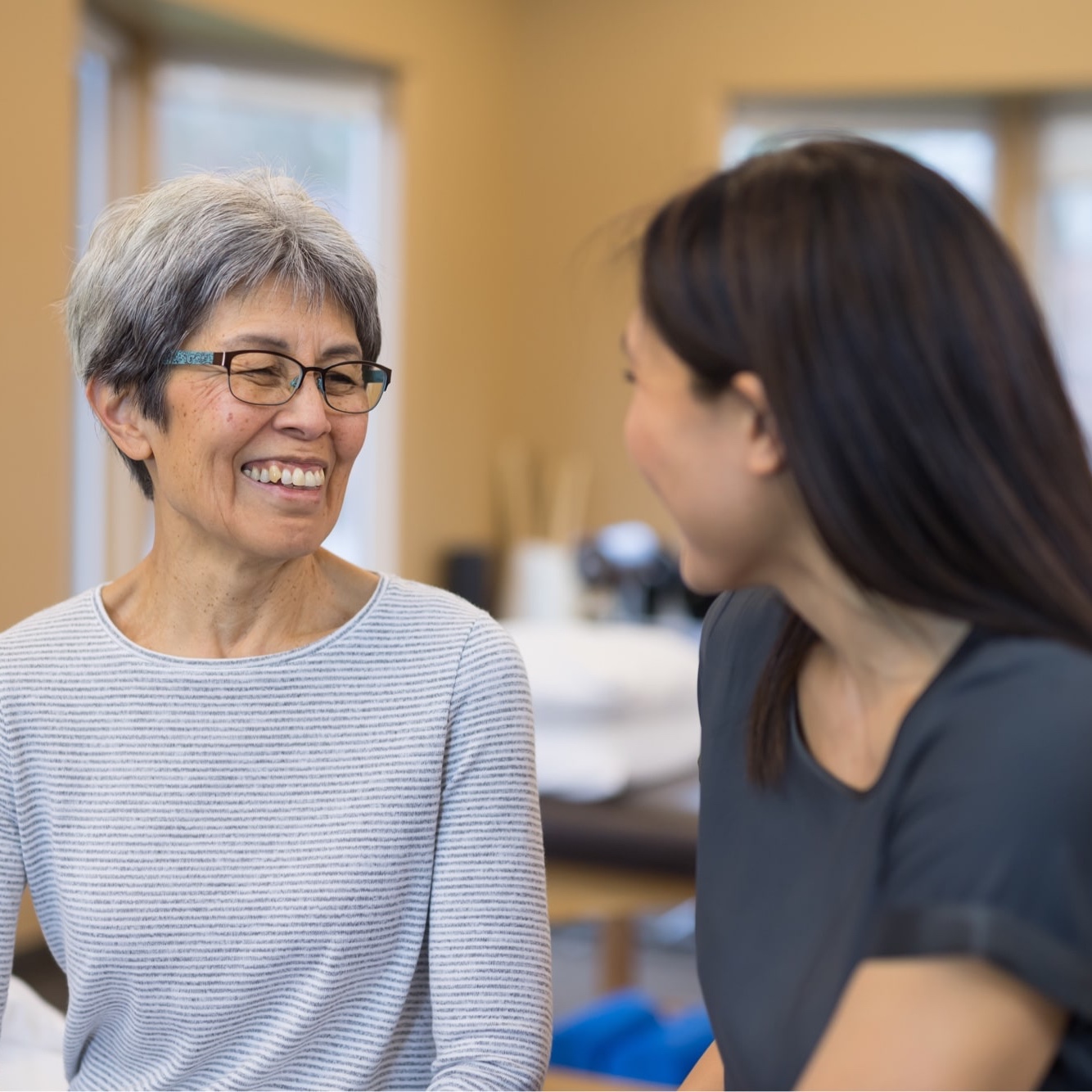 Therapist talking to elderly patient